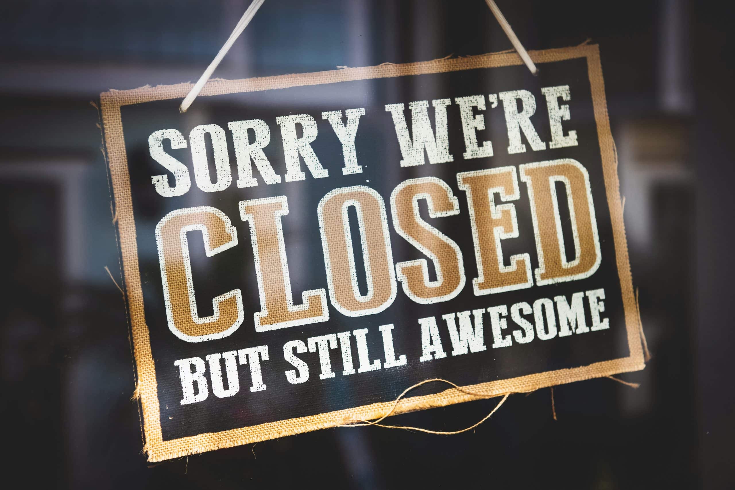 Hanging sign that reads "Sorry we're closed but still awesome"