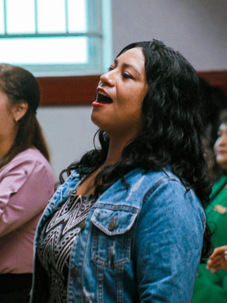Victoria Child Care Resource &Amp; Referral 1 Woman in a denim jacket singing with a group of people